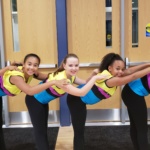 Junior dance company members pose at midnight madness